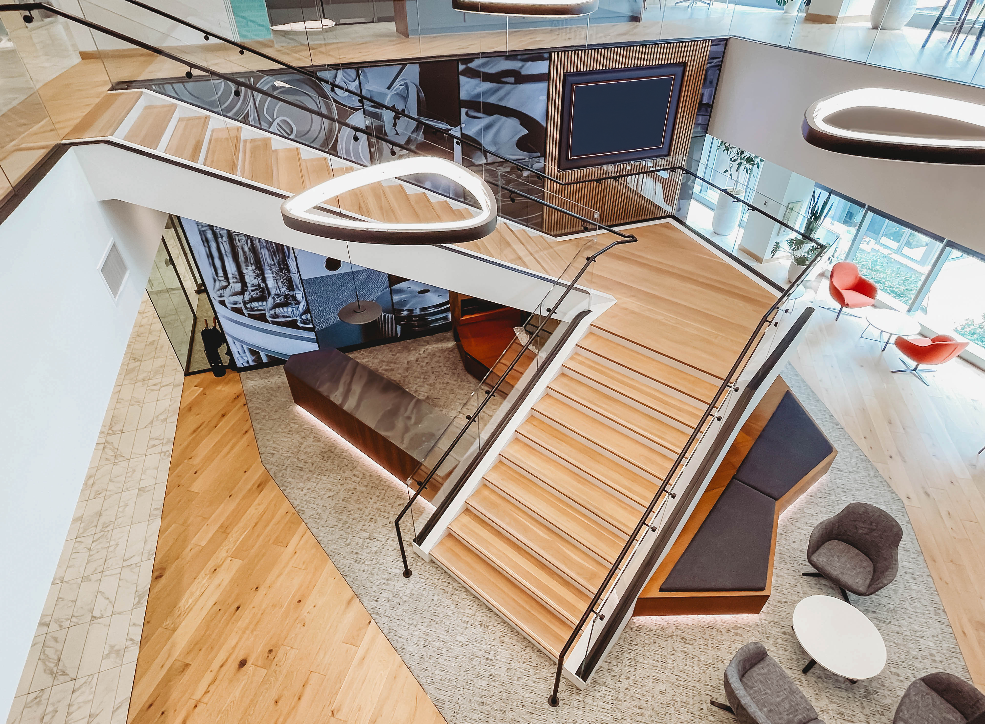 Grand entry stair with glass railing in a modern interior