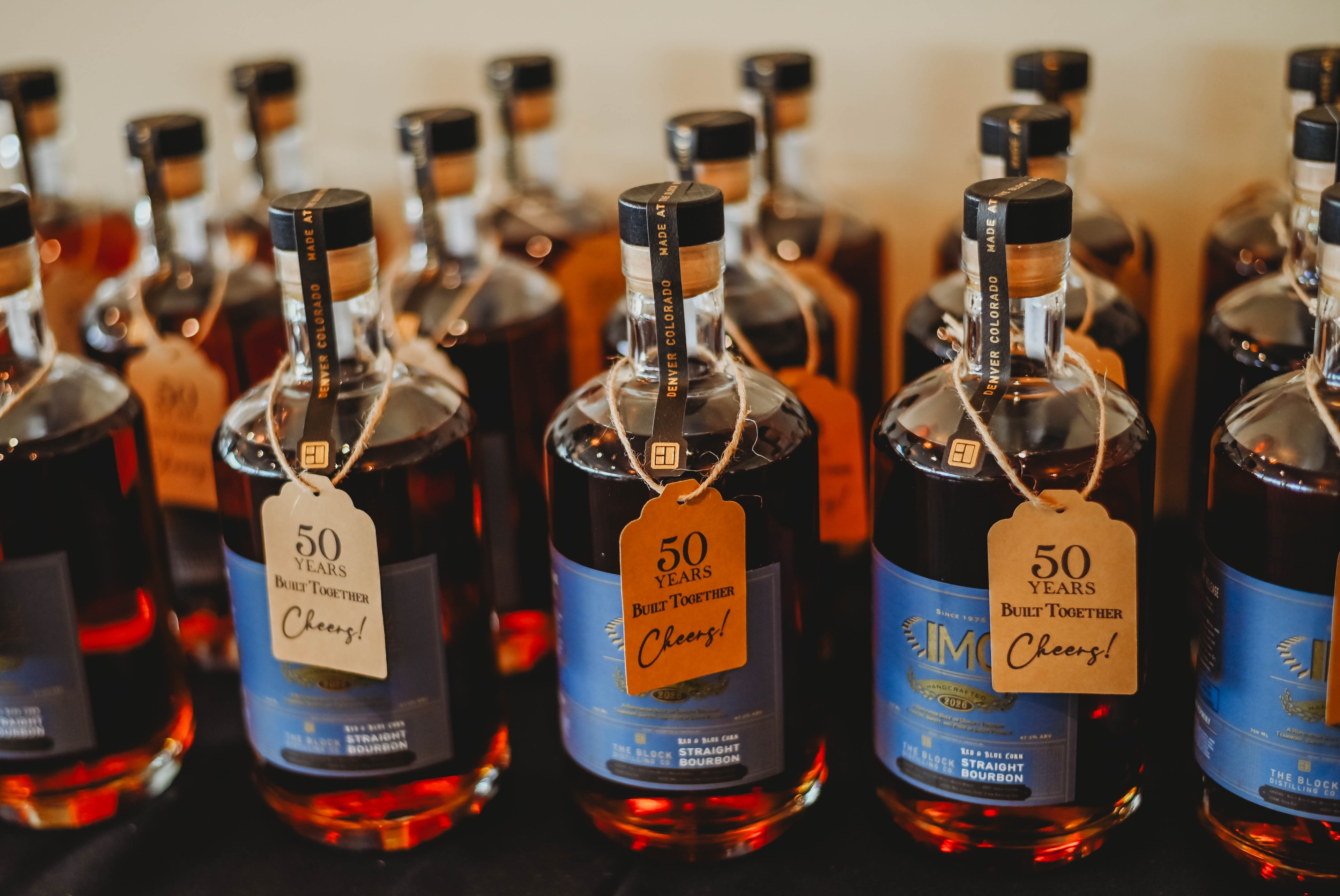 Custom IMC branded bourbon bottles celebrating 50 Years Built Together